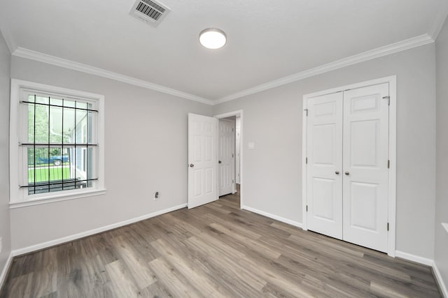 3603 Idaho St, Houston, TX 77021 - unfurnished bedroom with crown molding, wood finished floors, and a closet