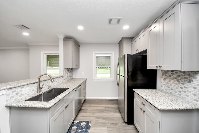 3603 Idaho St, Houston, TX 77021 - kitchen featuring stainless steel appliances, tasteful backsplash, a peninsula, gray cabinets, and recessed lighting