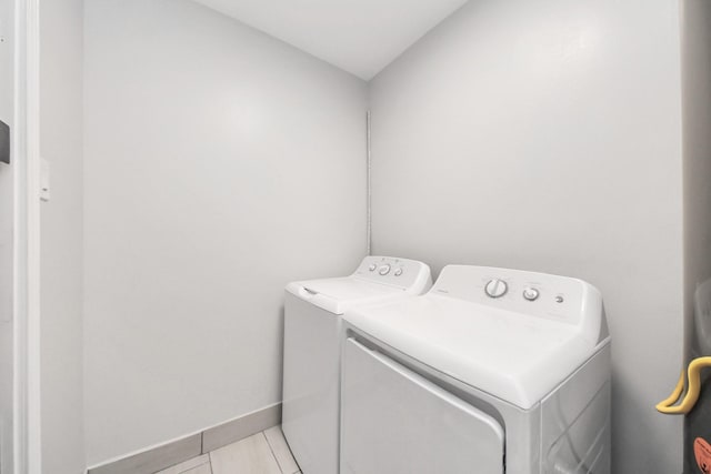 3603 Idaho St, Houston, TX 77021 - laundry area with washing machine and clothes dryer and light tile patterned floors