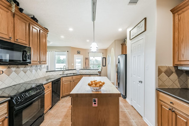 29218 Hay Meadow Ct, Waller, TX 77484 - kitchen with black appliances, backsplash, light tile patterned floors, a center island, and a peninsula
