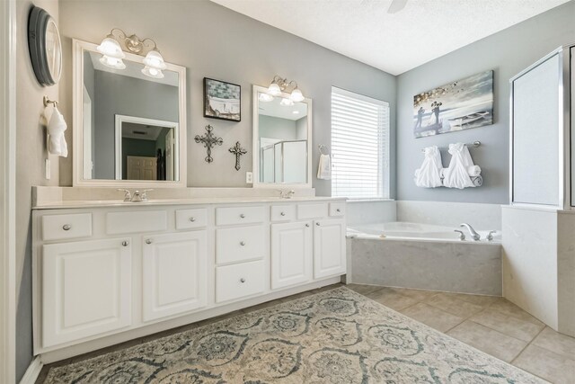 29218 Hay Meadow Ct, Waller, TX 77484 - full bath featuring a garden tub, double vanity, a stall shower, and tile patterned floors