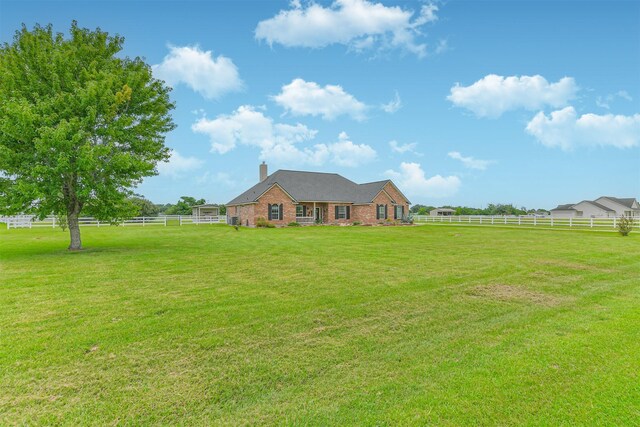 29218 Hay Meadow Ct, Waller, TX 77484 - view of front of property with a chimney, a fenced backyard, and brick siding