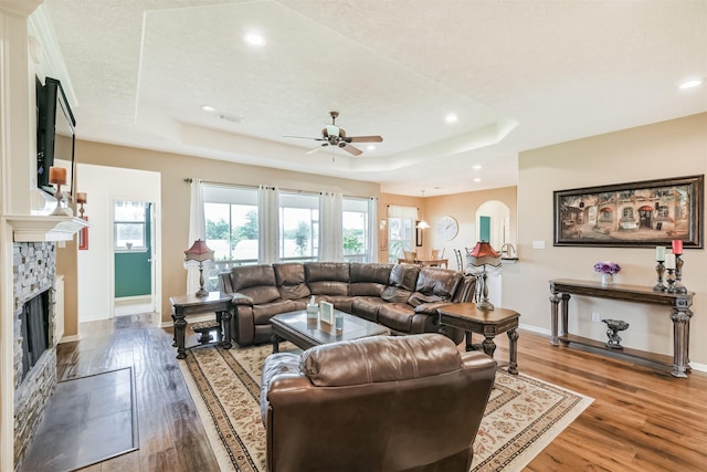 29218 Hay Meadow Ct, Waller, TX 77484 - living area featuring a ceiling fan, a raised ceiling, wood finished floors, arched walkways, and recessed lighting