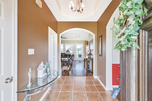 29218 Hay Meadow Ct, Waller, TX 77484 - foyer with arched walkways, light tile patterned flooring, and a chandelier