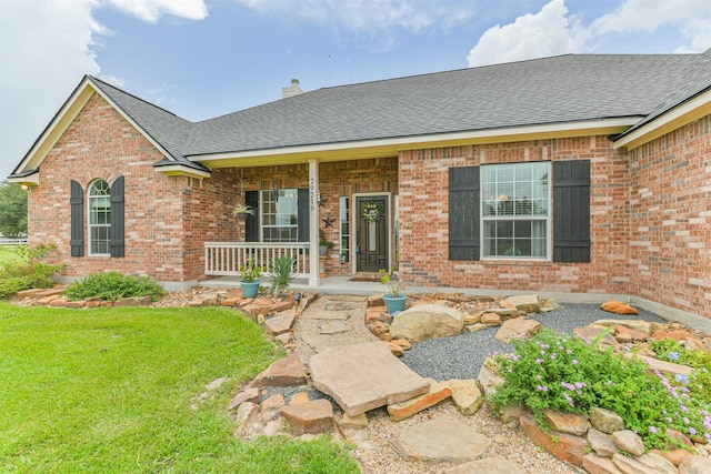 29218 Hay Meadow Ct, Waller, TX 77484 - view of front of house featuring a porch, a shingled roof, brick siding, and a chimney