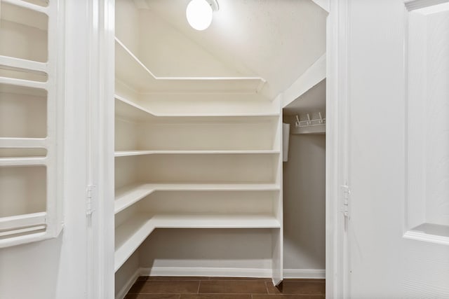 53 Silver Crescent Ct, The Woodlands, TX 77382 - walk in closet with vaulted ceiling and wood finished floors