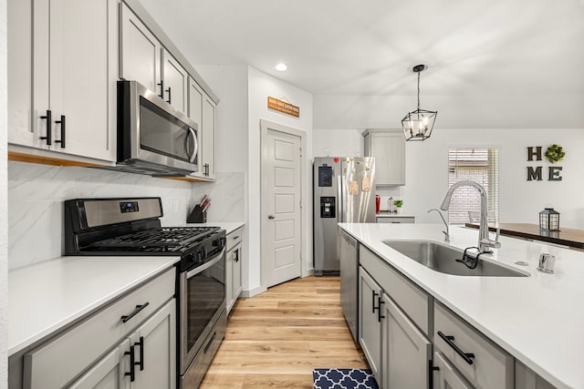 1618 William Scott St, Baytown, TX 77523 - kitchen featuring stainless steel appliances, light wood-type flooring, light countertops, tasteful backsplash, and recessed lighting