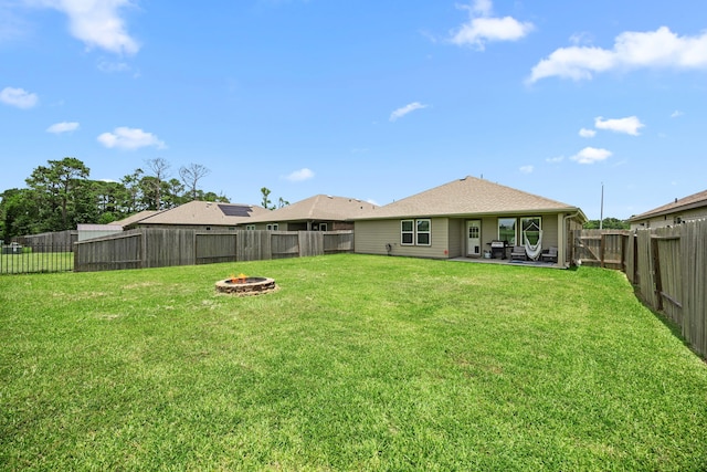 1618 William Scott St, Baytown, TX 77523 - rear view of house with a fire pit, a fenced backyard, and a patio
