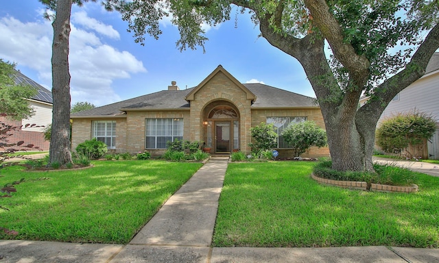 15407 Copper Branch Ln, Houston, TX 77095 - view of front of property featuring brick siding, a front lawn, roof with shingles, and a chimney