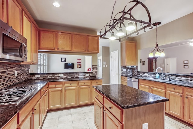 15407 Copper Branch Ln, Houston, TX 77095 - kitchen with stainless steel appliances, light tile patterned floors, decorative backsplash, dark stone countertops, and a peninsula
