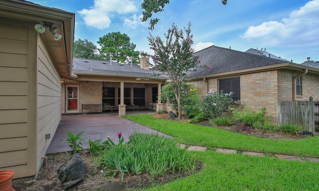 15407 Copper Branch Ln, Houston, TX 77095 - back of house with a patio, a chimney, roof with shingles, and brick siding