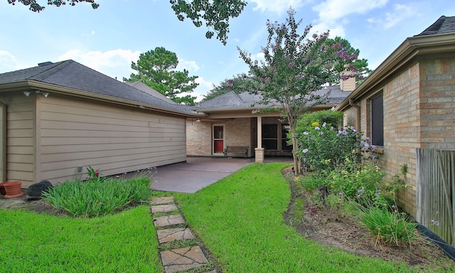 15407 Copper Branch Ln, Houston, TX 77095 - back of property featuring a patio, a lawn, roof with shingles, and brick siding