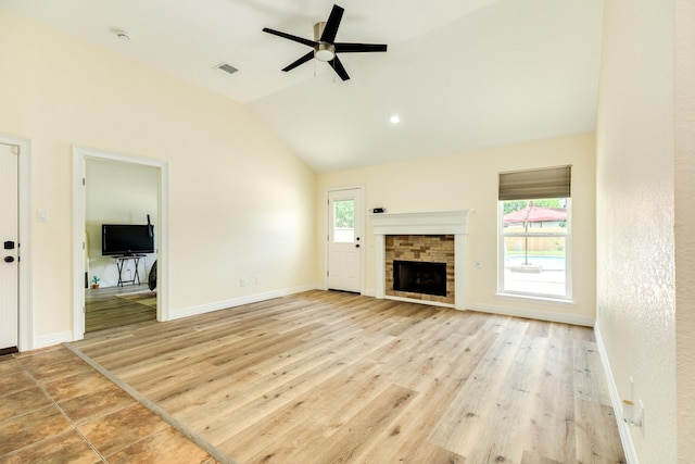 21 Alexander Ct, Angleton, TX 77515 - unfurnished living room featuring ceiling fan, lofted ceiling, light wood-type flooring, and a fireplace