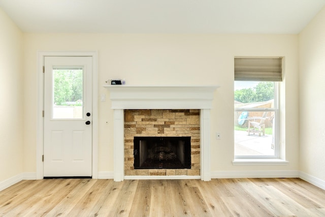 21 Alexander Ct, Angleton, TX 77515 - unfurnished living room featuring a fireplace and wood finished floors