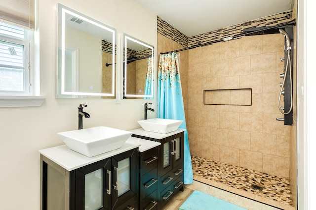 21 Alexander Ct, Angleton, TX 77515 - bathroom featuring a tile shower and double vanity