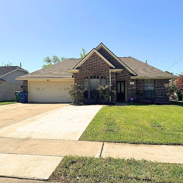 21 Alexander Ct, Angleton, TX 77515 - view of front of house featuring a front lawn, concrete driveway, brick siding, and a garage