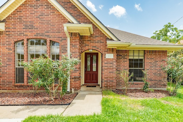 21 Alexander Ct, Angleton, TX 77515 - doorway to property featuring a shingled roof and brick siding