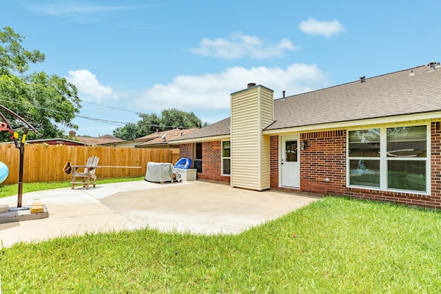21 Alexander Ct, Angleton, TX 77515 - back of property with a patio area, roof with shingles, brick siding, and a chimney