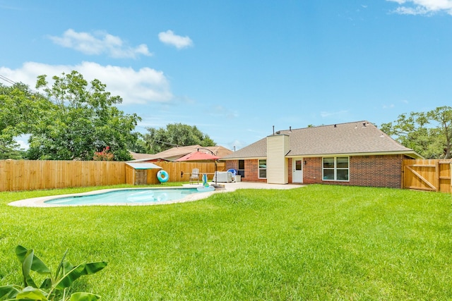 21 Alexander Ct, Angleton, TX 77515 - back of property featuring a fenced backyard, a patio, brick siding, and roof with shingles