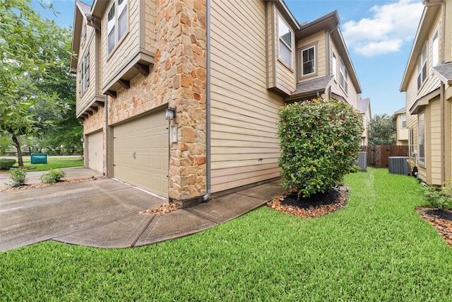9 Cheswood Manor Dr, Spring, TX 77382 - view of side of property featuring a garage, driveway, and stone siding