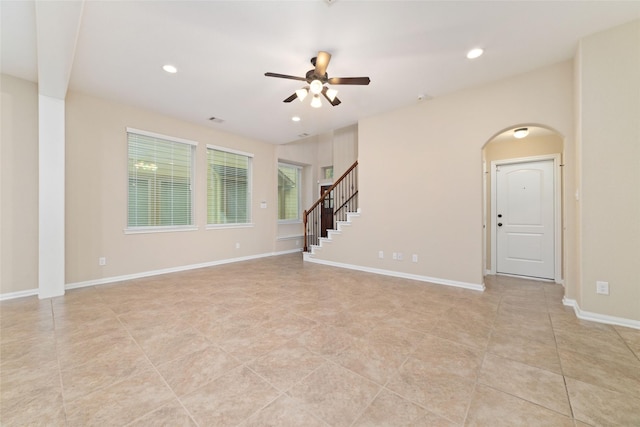 9 Cheswood Manor Dr, Spring, TX 77382 - unfurnished room featuring a ceiling fan, arched walkways, light tile patterned floors, recessed lighting, and stairway