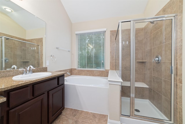 9 Cheswood Manor Dr, Spring, TX 77382 - bathroom with lofted ceiling, vanity, a shower stall, a garden tub, and tile patterned floors