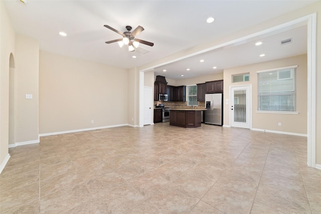 9 Cheswood Manor Dr, Spring, TX 77382 - unfurnished living room with ceiling fan, recessed lighting, arched walkways, and light tile patterned floors