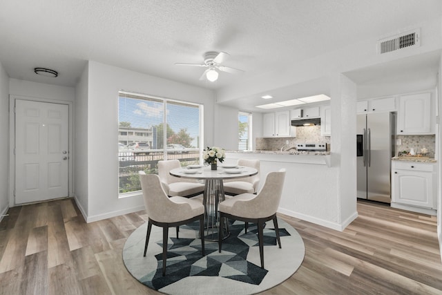 781 Country Place Dr Unit 2083, Houston, TX 77079 - dining space with ceiling fan, light wood-style flooring, and a textured ceiling
