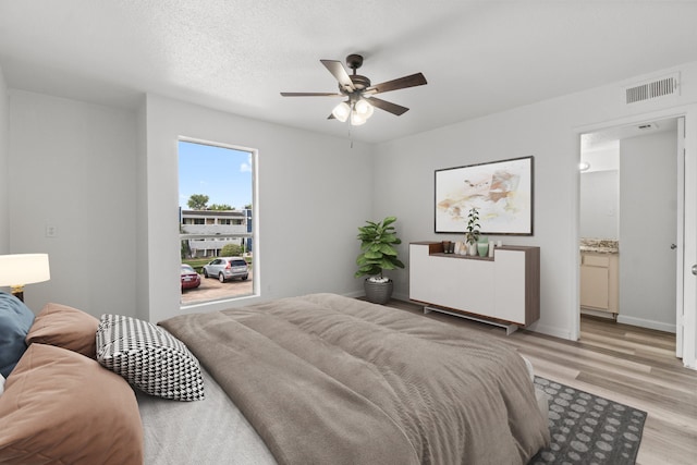 781 Country Place Dr Unit 2083, Houston, TX 77079 - bedroom with light wood-type flooring, ceiling fan, and connected bathroom