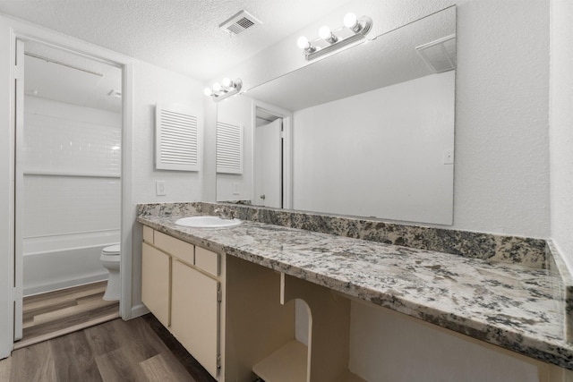781 Country Place Dr Unit 2083, Houston, TX 77079 - full bath with wood finished floors, vanity, bathing tub / shower combination, and a textured ceiling