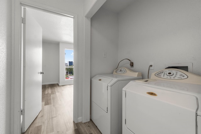 781 Country Place Dr Unit 2083, Houston, TX 77079 - washroom with light wood-style flooring and independent washer and dryer