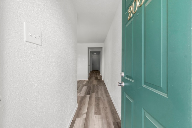 781 Country Place Dr Unit 2083, Houston, TX 77079 - hall featuring dark wood finished floors and a textured wall