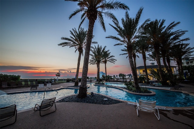 4121 Pointe W Dr Unit 103, Galveston, TX 77554 - pool at dusk with a community pool and a patio