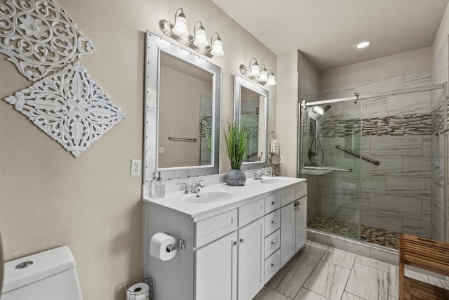 4121 Pointe W Dr Unit 103, Galveston, TX 77554 - bathroom featuring double vanity, a stall shower, recessed lighting, and marble finish flooring