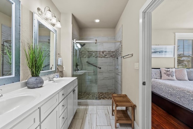 4121 Pointe W Dr Unit 103, Galveston, TX 77554 - ensuite bathroom featuring double vanity, a stall shower, and recessed lighting