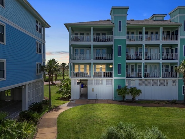 4121 Pointe W Dr Unit 103, Galveston, TX 77554 - back of house at dusk with a yard
