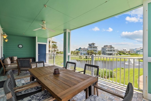4121 Pointe W Dr Unit 103, Galveston, TX 77554 - view of patio featuring a ceiling fan, a water view, a residential view, and outdoor dining space