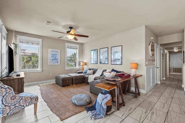 4121 Pointe W Dr Unit 103, Galveston, TX 77554 - living room featuring baseboards and a ceiling fan
