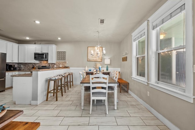 4121 Pointe W Dr Unit 103, Galveston, TX 77554 - dining space featuring a chandelier and recessed lighting