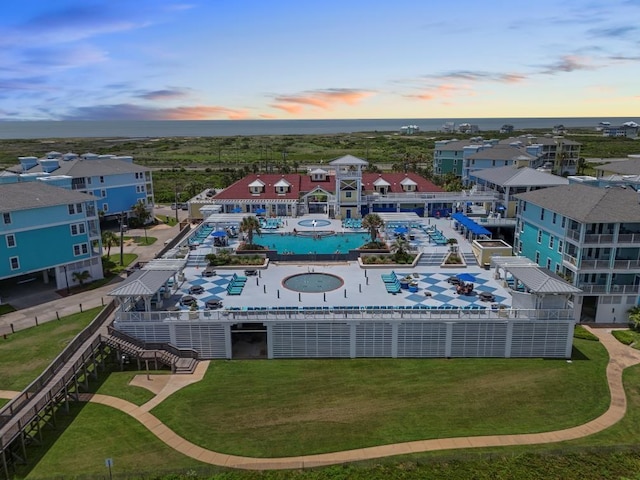 4121 Pointe W Dr Unit 103, Galveston, TX 77554 - aerial view at dusk of view of pool area and a water view