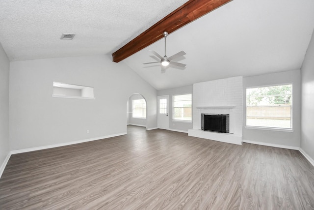 17715 Glenpatti Dr, Houston, TX 77084 - unfurnished living room with ceiling fan, wood finished floors, a fireplace, and a textured ceiling