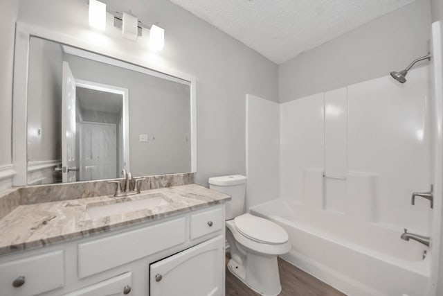 17715 Glenpatti Dr, Houston, TX 77084 - full bath featuring vanity, a textured ceiling, wood finished floors, and washtub / shower combination