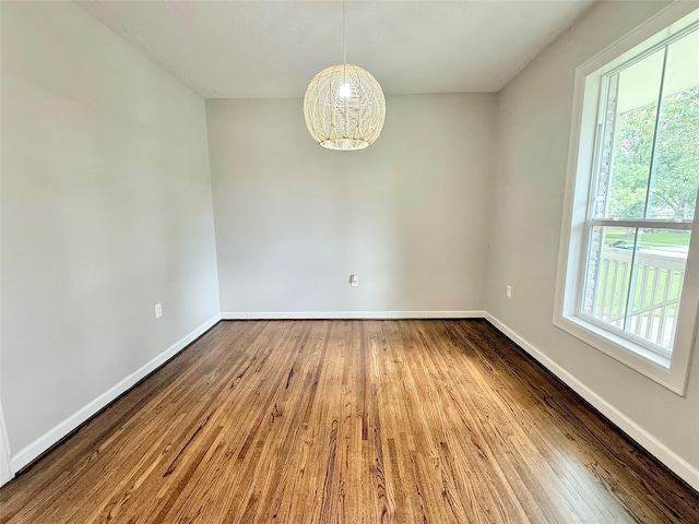 11418 Braewick Dr, Houston, TX 77035 - empty room with plenty of natural light, wood finished floors, and a chandelier