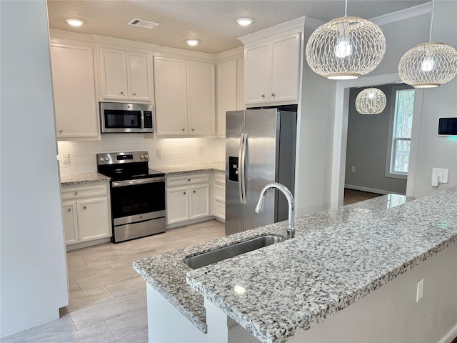 11418 Braewick Dr, Houston, TX 77035 - kitchen featuring appliances with stainless steel finishes, white cabinets, backsplash, and light stone countertops