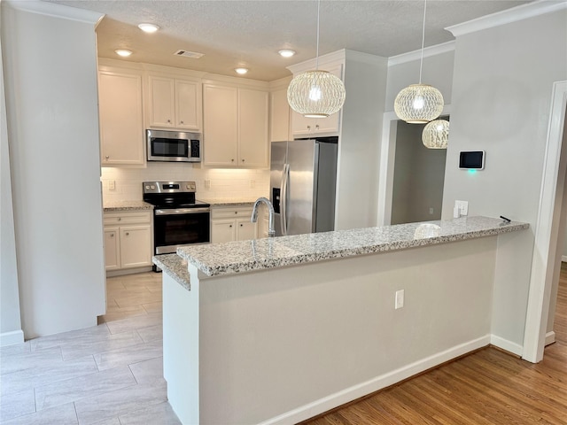11418 Braewick Dr, Houston, TX 77035 - kitchen featuring stainless steel appliances, crown molding, decorative backsplash, light stone countertops, and white cabinetry