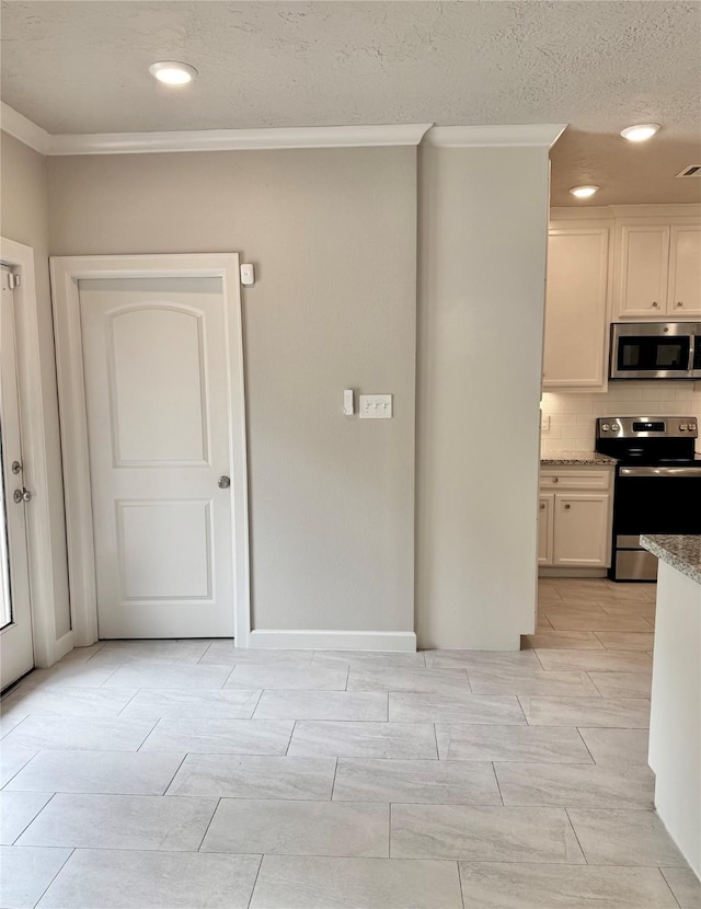 11418 Braewick Dr, Houston, TX 77035 - kitchen featuring stainless steel appliances, crown molding, tasteful backsplash, light stone countertops, and white cabinets