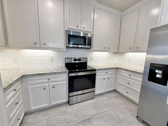 11418 Braewick Dr, Houston, TX 77035 - kitchen with appliances with stainless steel finishes, decorative backsplash, white cabinetry, and light stone counters