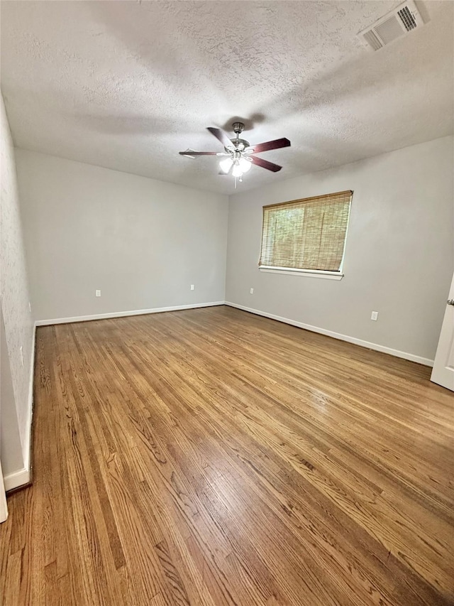 11418 Braewick Dr, Houston, TX 77035 - spare room featuring wood finished floors, a textured ceiling, and a ceiling fan