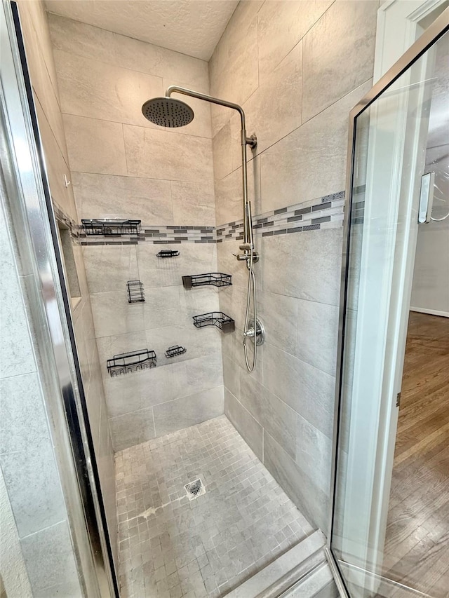 11418 Braewick Dr, Houston, TX 77035 - full bathroom with a stall shower and wood finished floors