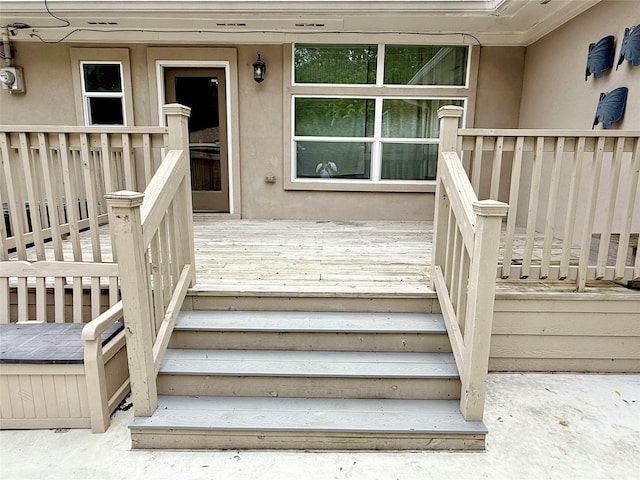 11418 Braewick Dr, Houston, TX 77035 - view of exterior entry with stucco siding and a wooden deck